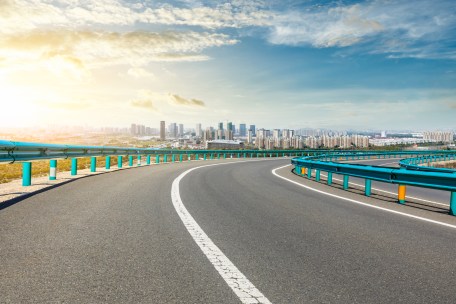 Asphalt highway passing through the city above in Shanghai at sunset